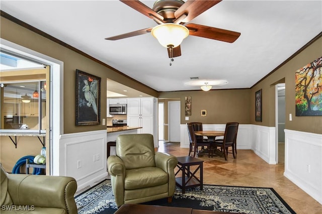 living room featuring ceiling fan and ornamental molding