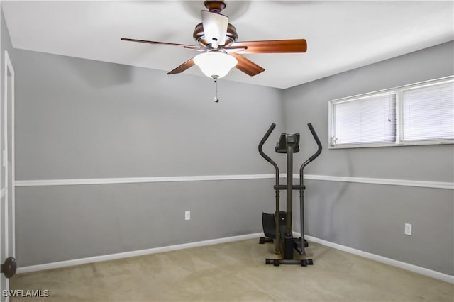 exercise area featuring light carpet and ceiling fan