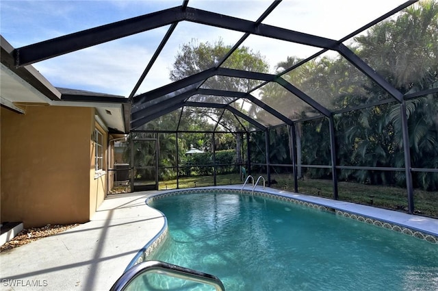 view of pool featuring a patio and glass enclosure