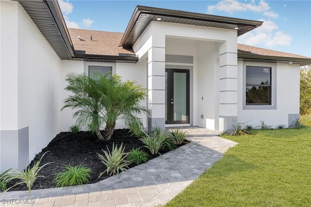 entrance to property featuring a lawn