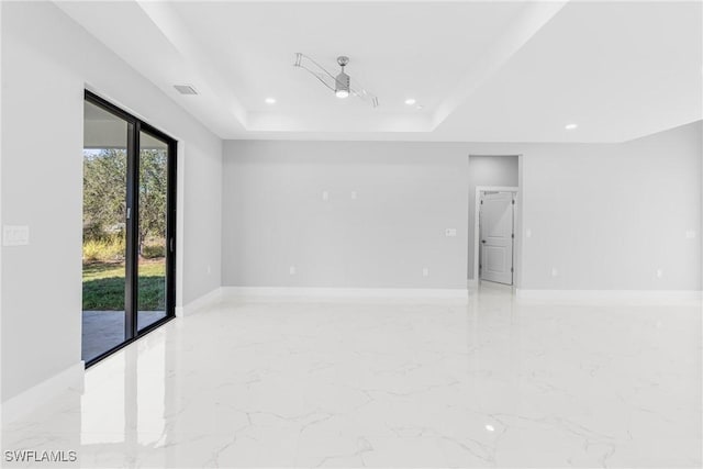 empty room featuring a tray ceiling