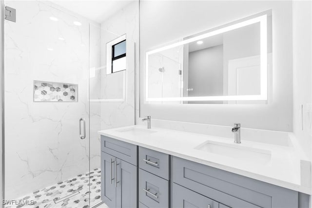 bathroom with vanity and a shower with shower door