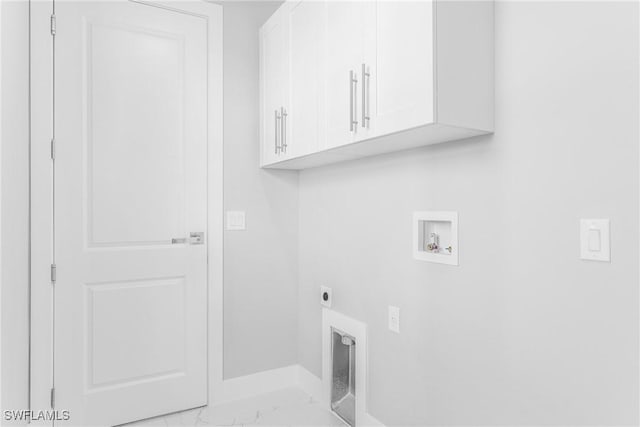 laundry room featuring electric dryer hookup, hookup for a washing machine, and cabinets