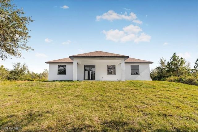 rear view of house with a yard