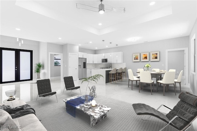 living room with ceiling fan and french doors