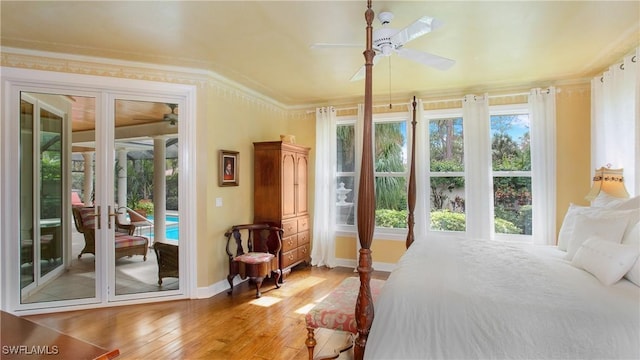 bedroom with ceiling fan, french doors, crown molding, light hardwood / wood-style floors, and access to outside