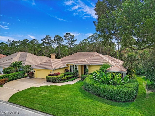 view of front of house with a garage and a front lawn