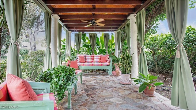 unfurnished sunroom featuring beamed ceiling and wood ceiling