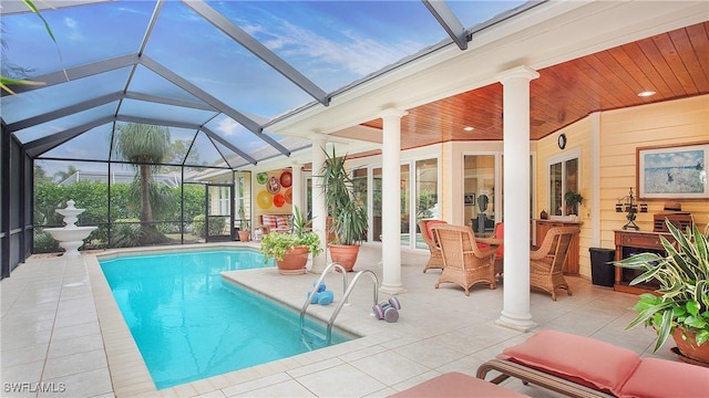 view of swimming pool featuring a patio and glass enclosure