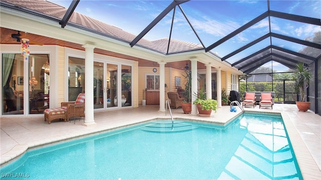 view of pool featuring ceiling fan, a patio area, and a lanai