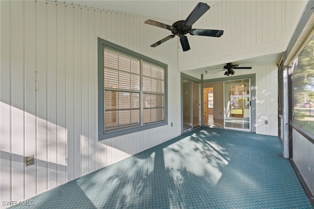 unfurnished sunroom featuring ceiling fan