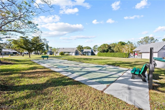 view of property's community with a yard