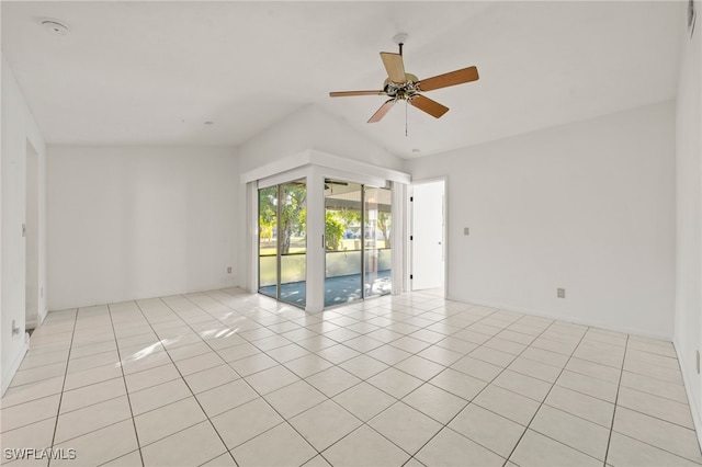 spare room featuring ceiling fan, light tile patterned floors, and vaulted ceiling