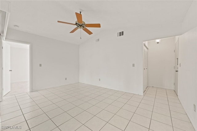 tiled empty room featuring ceiling fan and vaulted ceiling