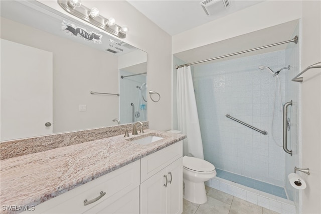 bathroom with tile patterned floors, vanity, toilet, and walk in shower