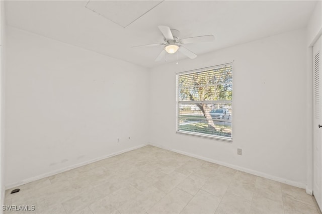 unfurnished room with ceiling fan and light tile patterned floors