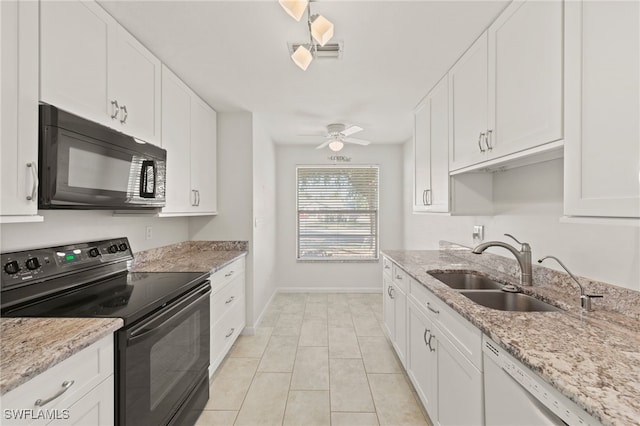 kitchen with white cabinetry, sink, black appliances, and light stone counters