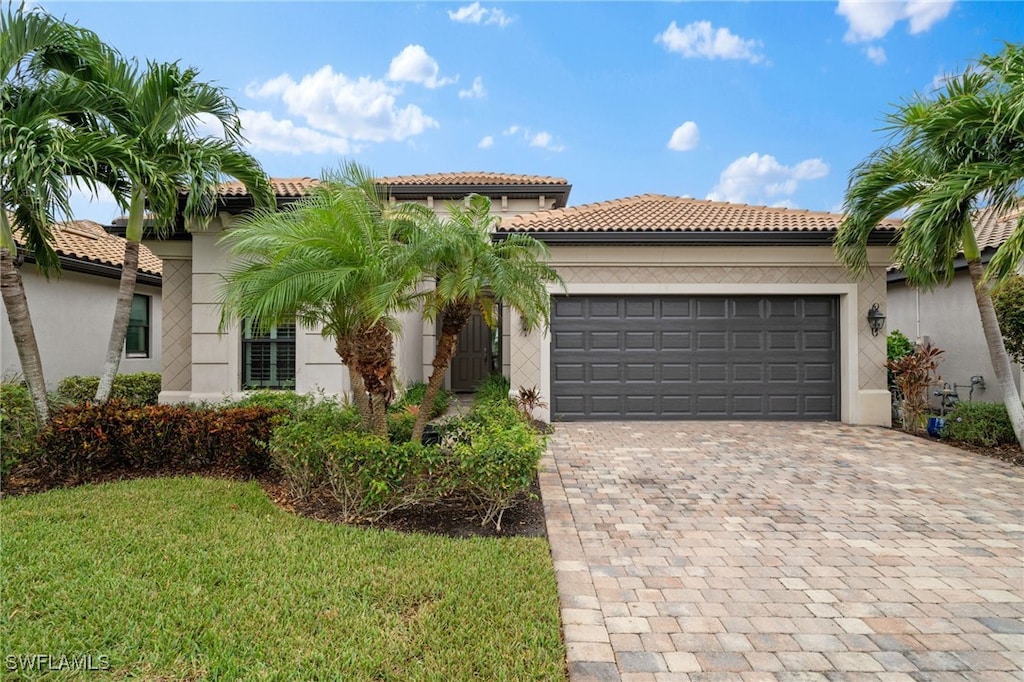 mediterranean / spanish-style home with a garage