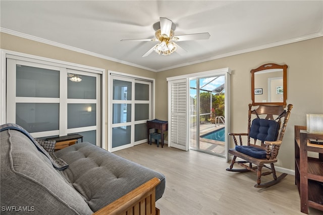 interior space with crown molding, ceiling fan, and light wood-type flooring