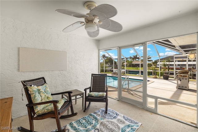 sunroom featuring ceiling fan