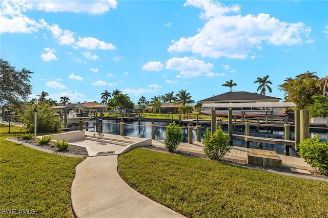 surrounding community with a boat dock, a yard, and a water view