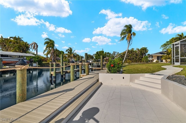 dock area featuring a water view and a yard