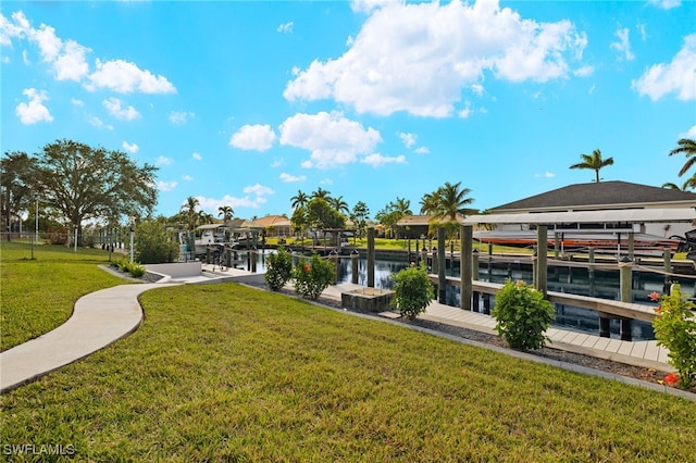 dock area with a water view and a lawn