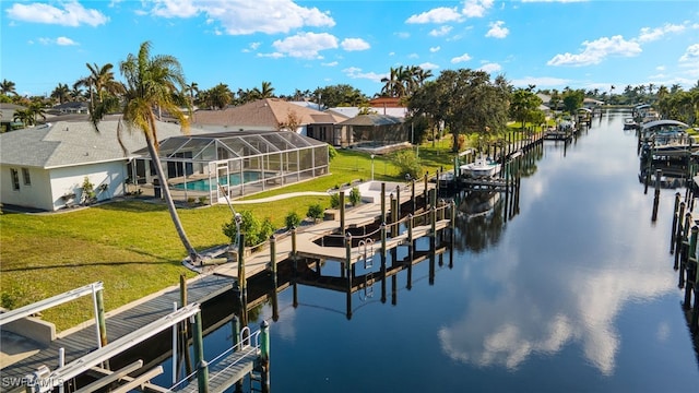 view of dock featuring a lawn, glass enclosure, and a water view