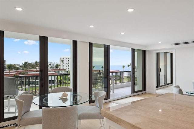 dining space with plenty of natural light and light hardwood / wood-style flooring