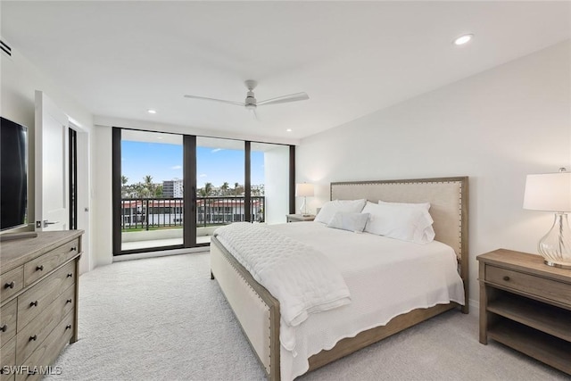 carpeted bedroom featuring access to exterior, ceiling fan, and expansive windows