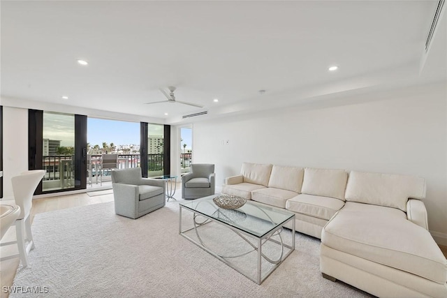 living room featuring light hardwood / wood-style floors and ceiling fan