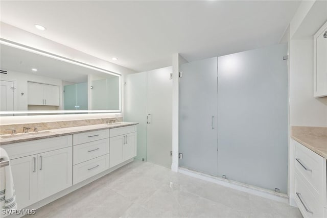 bathroom with vanity and an enclosed shower