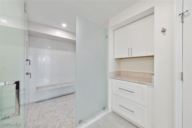 bathroom with tile patterned floors and walk in shower