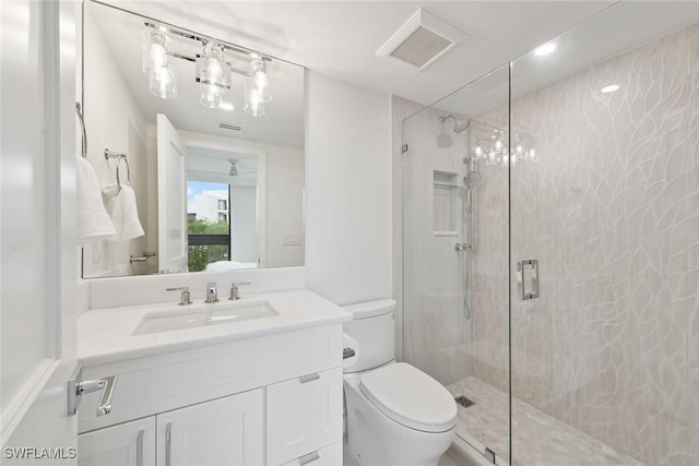 bathroom with vanity, toilet, and an enclosed shower