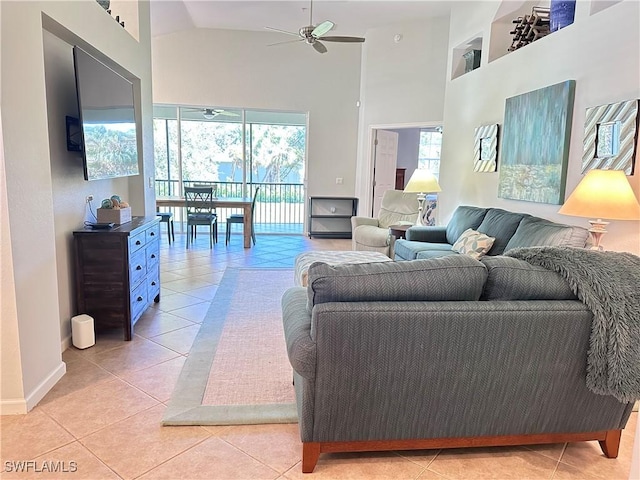 living room featuring ceiling fan, light tile patterned floors, and high vaulted ceiling