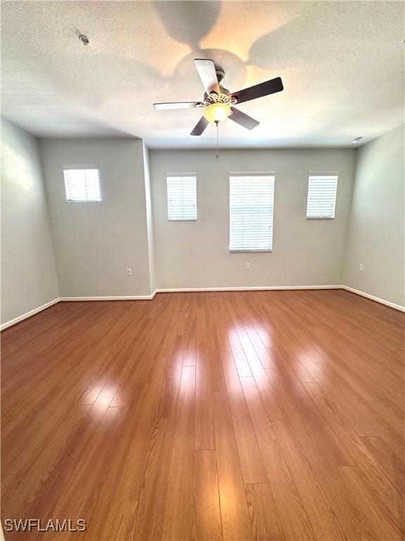 spare room featuring hardwood / wood-style floors, a textured ceiling, and ceiling fan