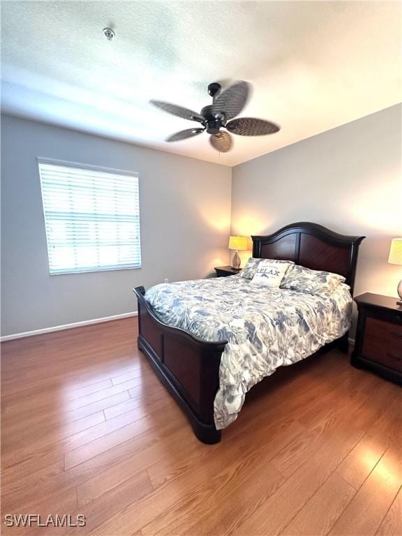 bedroom featuring hardwood / wood-style flooring and ceiling fan