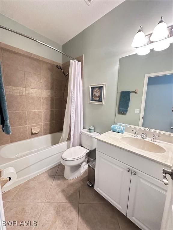 full bathroom with tile patterned floors, shower / bathtub combination with curtain, vanity, and toilet