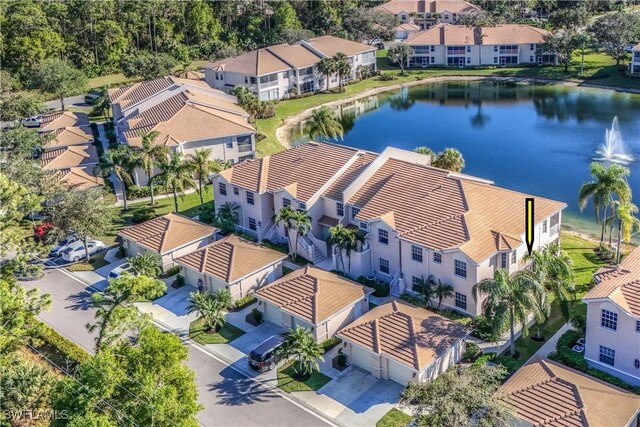 birds eye view of property featuring a water view and a residential view