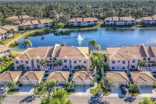 birds eye view of property with a water view and a residential view