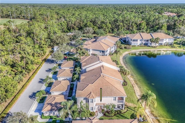 birds eye view of property featuring a residential view, a water view, and a forest view