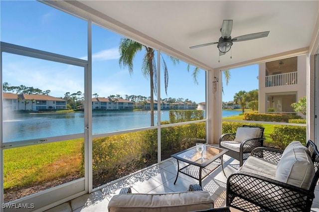 sunroom with a water view, plenty of natural light, and ceiling fan