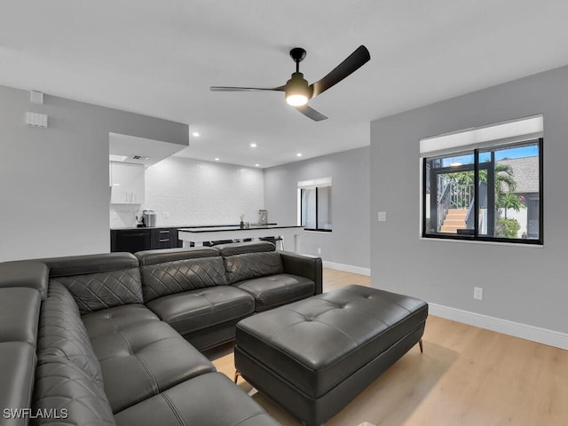 cinema room featuring recessed lighting, a ceiling fan, light wood-type flooring, and baseboards