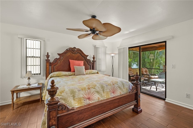 bedroom featuring access to exterior, wood-type flooring, and multiple windows