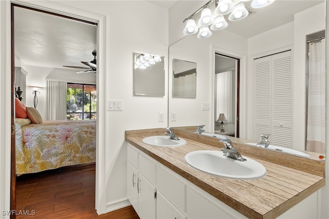 bathroom with ceiling fan, vanity, and hardwood / wood-style flooring