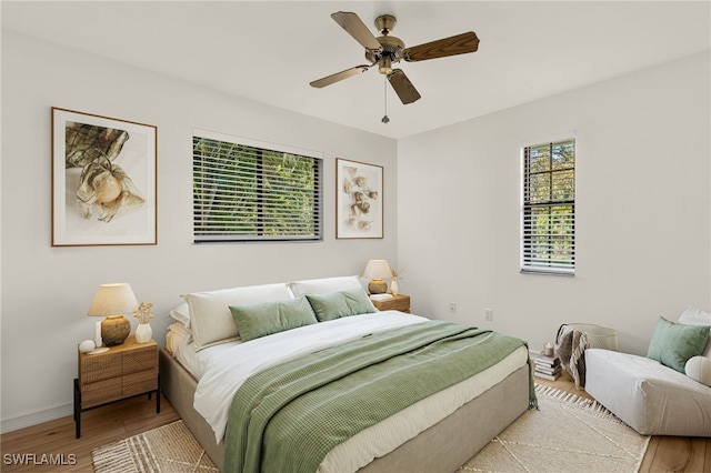 bedroom with ceiling fan and light hardwood / wood-style floors