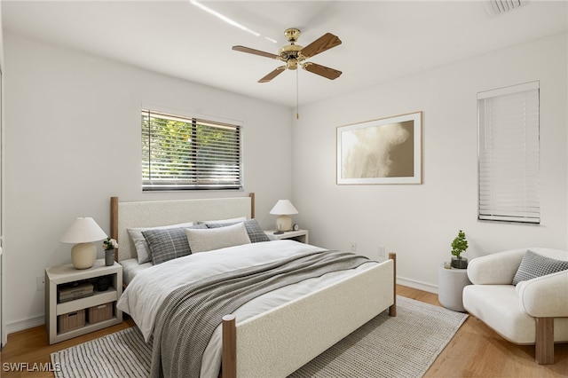 bedroom with ceiling fan and light wood-type flooring