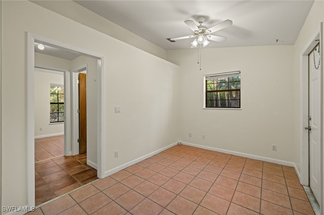 tiled empty room with ceiling fan and lofted ceiling