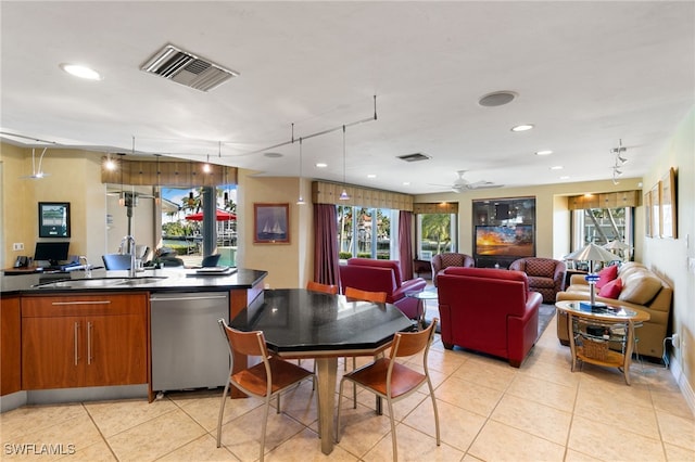 dining space featuring sink, track lighting, ceiling fan, and light tile patterned flooring