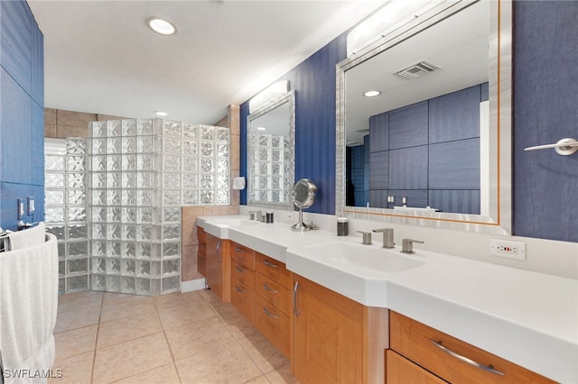 bathroom featuring tile patterned flooring, vanity, and tile walls